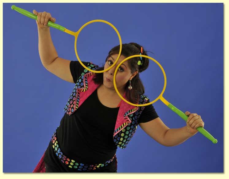 The Bubble Lady making a silly face with two bubble wand hoops.