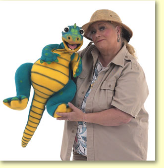 Photograph of Margaret Clauder dressed as Paleo Maggie, with a read-a-saurus puppet.