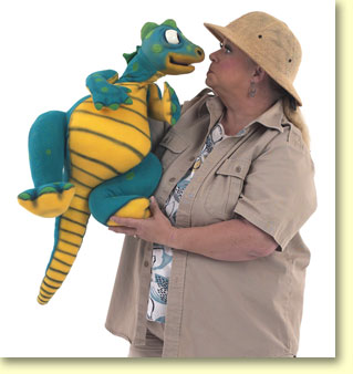Photo of Margaret Clauder dressed as Paleo Maggie, holding her read-a-saurus puppet.