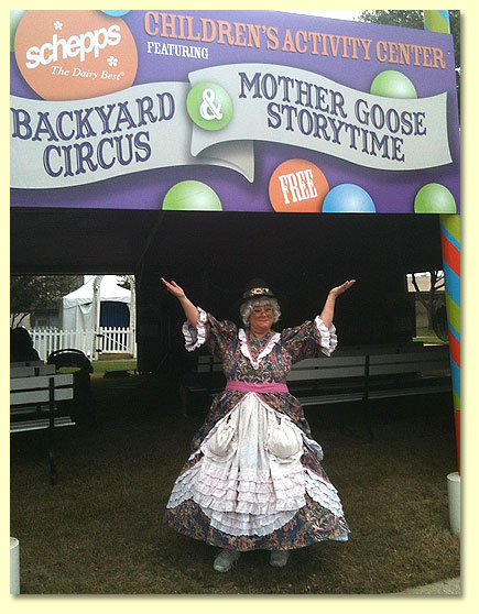 Mother Goose stands at the doorway to the children's Storytime tent, welcoming gusts to enjoy the show.